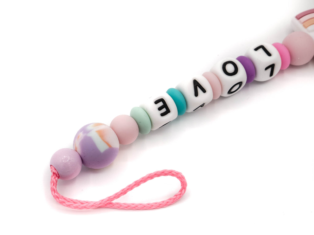Handgefertigte und individuelle Schnullerkette rosa-bunt Regenborgen - Schnullerkettenwelt